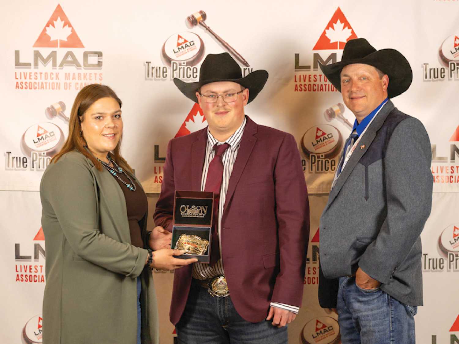 Man/Sask Champion Auctioneer Ty Culter receives his award presented by Boehringer Ingelheim rep Bria Bently and LMAC President Allan Munroe.
